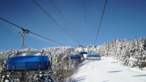 Ski lifts on Mount Snow during the winter with snow on the slopes.